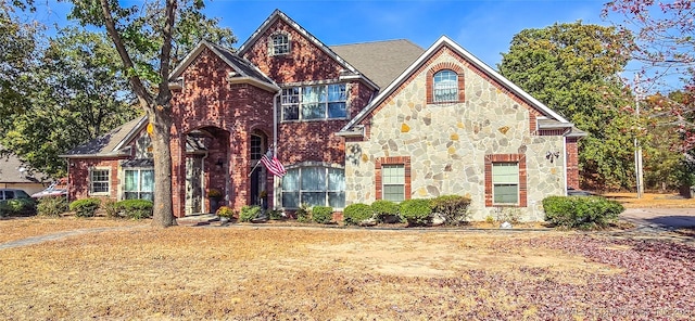 view of front of home with brick siding and stone siding