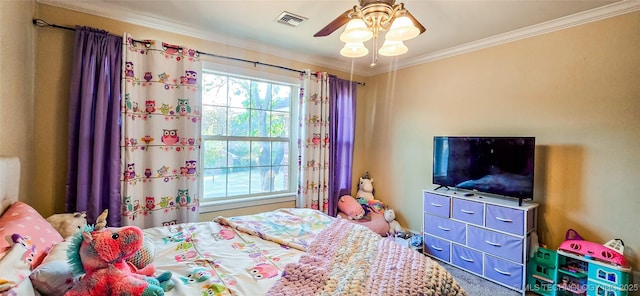 carpeted bedroom featuring visible vents, ornamental molding, and ceiling fan