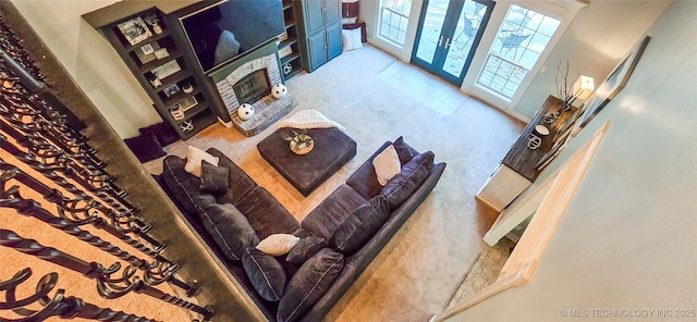 carpeted living room with a brick fireplace