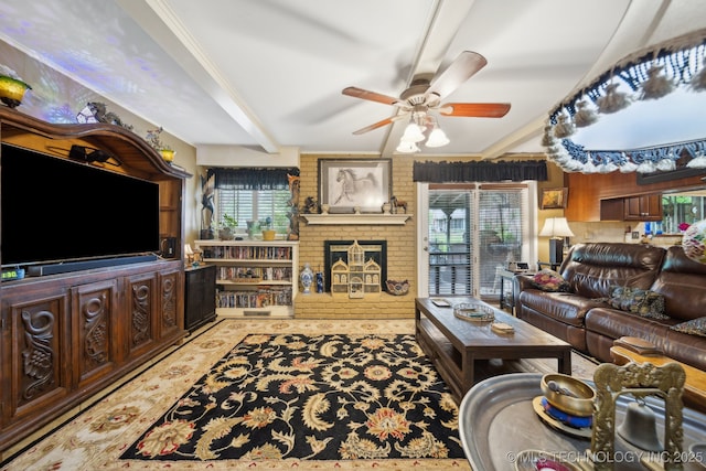 living room with plenty of natural light, a ceiling fan, a fireplace, and ornamental molding