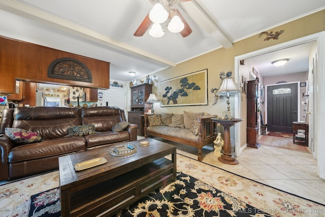 living area featuring ornamental molding, ceiling fan, light tile patterned floors, and beamed ceiling