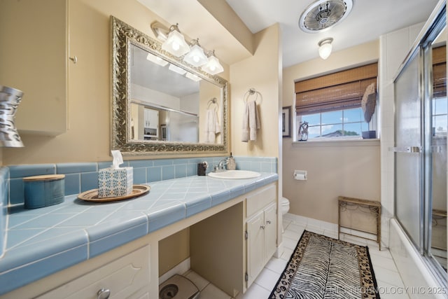 bathroom with vanity, an enclosed shower, tile patterned floors, and toilet