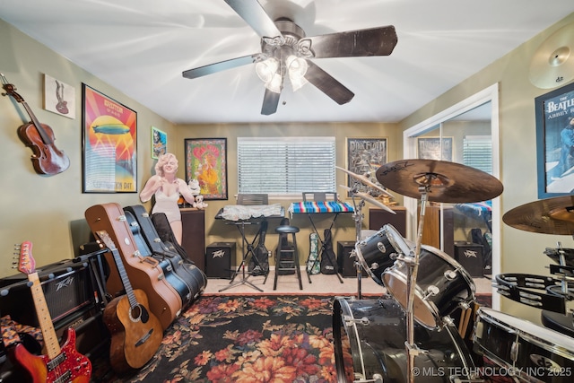 rec room featuring carpet and a ceiling fan