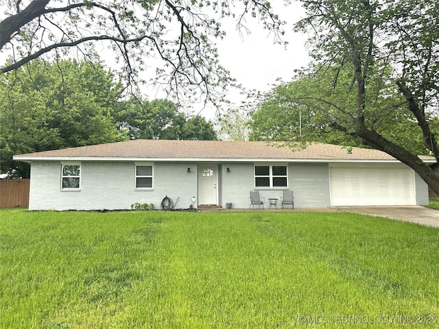 ranch-style house featuring concrete driveway, fence, a front yard, and a garage