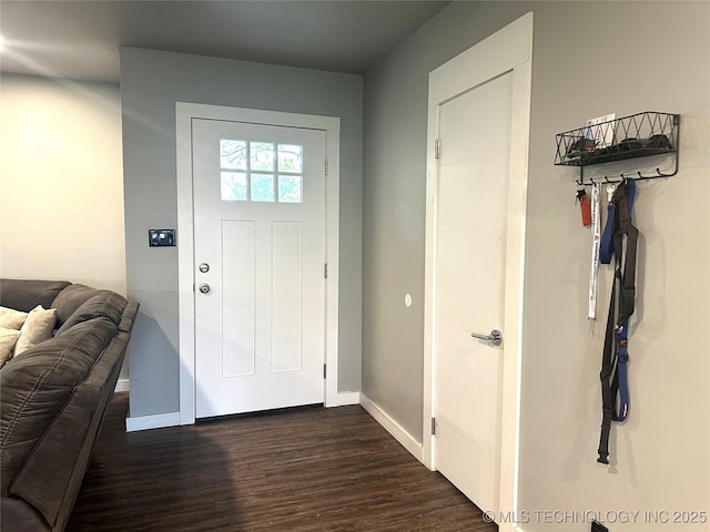 foyer with baseboards and dark wood-style flooring