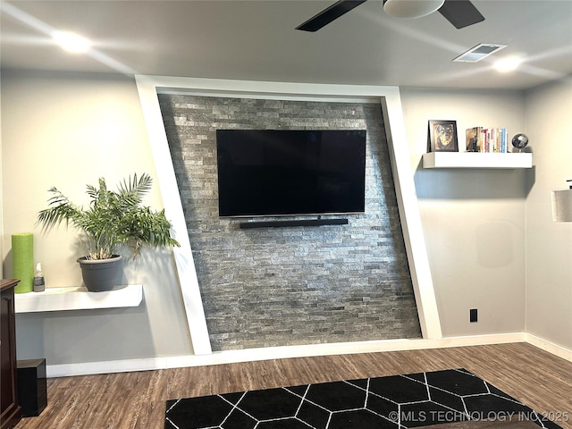 room details featuring visible vents, baseboards, and wood finished floors