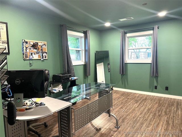 home office featuring baseboards, wood finished floors, and visible vents