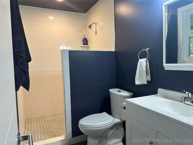 bathroom featuring vanity, a walk in shower, and toilet