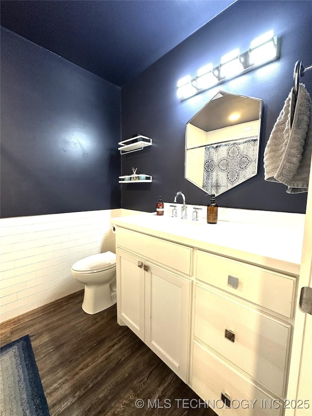 full bathroom with toilet, wood finished floors, and vanity