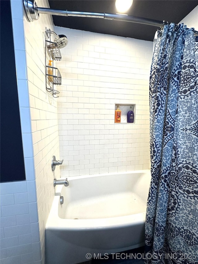 bathroom featuring shower / bath combo with shower curtain and tile walls