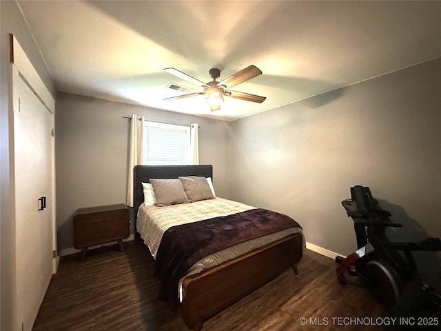 bedroom with baseboards, a ceiling fan, wood finished floors, and visible vents