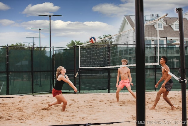 view of tennis court featuring fence