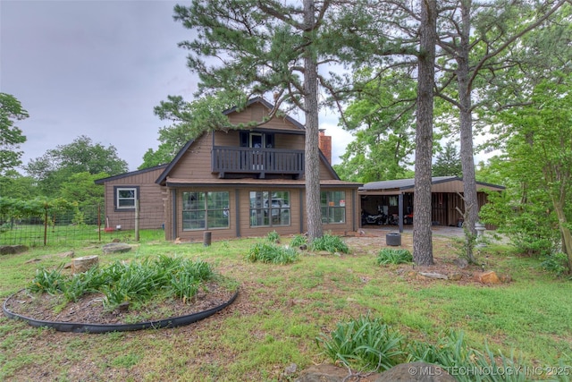 16703 Grisham Ave, Sapulpa, OK 74066 - back of house featuring a chimney, a balcony, and a carport