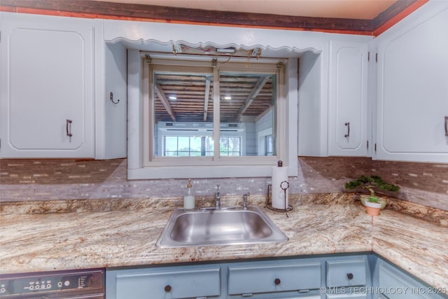 16703 Grisham Ave, Sapulpa, OK 74066 - kitchen with a sink, decorative backsplash, white cabinets, and light countertops
