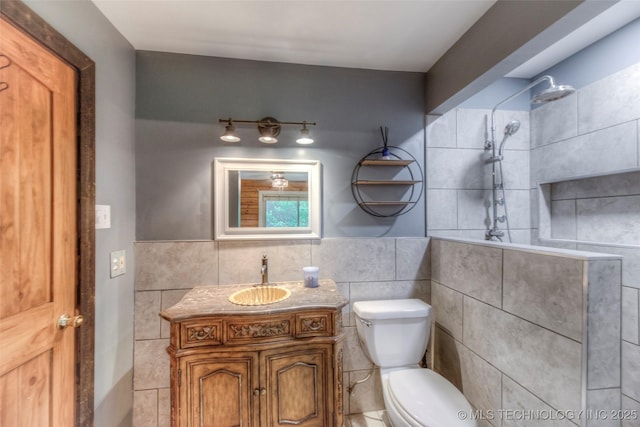 16703 Grisham Ave, Sapulpa, OK 74066 - full bathroom featuring tile walls, tiled shower, toilet, vanity, and wainscoting