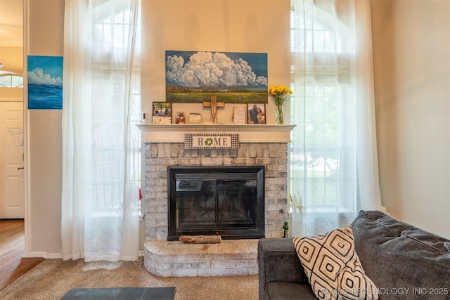 room details with a brick fireplace and carpet flooring