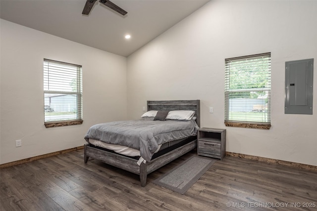 bedroom with high vaulted ceiling, baseboards, electric panel, and wood finished floors