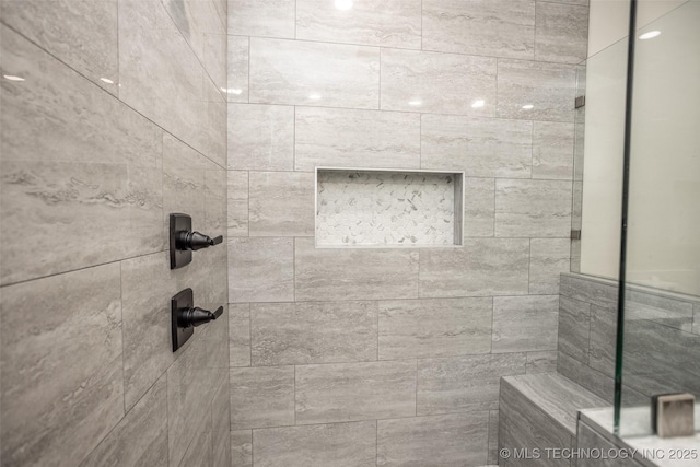 bathroom with a tile shower