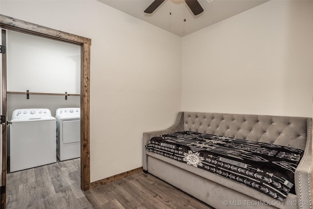 bedroom featuring baseboards, a ceiling fan, wood finished floors, and washing machine and clothes dryer