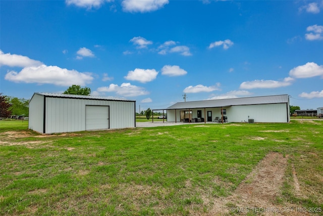back of house with a lawn, an outbuilding, and an outdoor structure