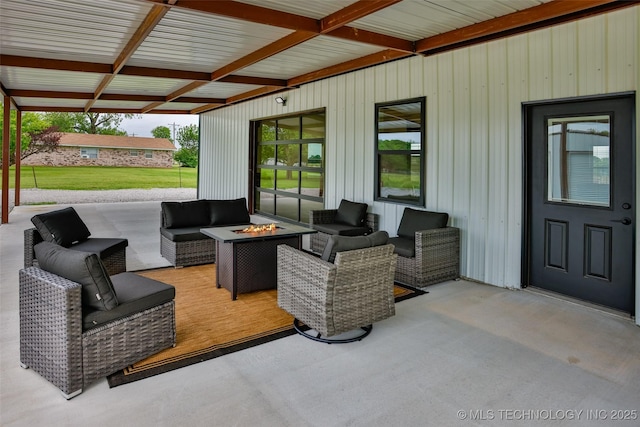 view of patio featuring an outdoor living space with a fire pit