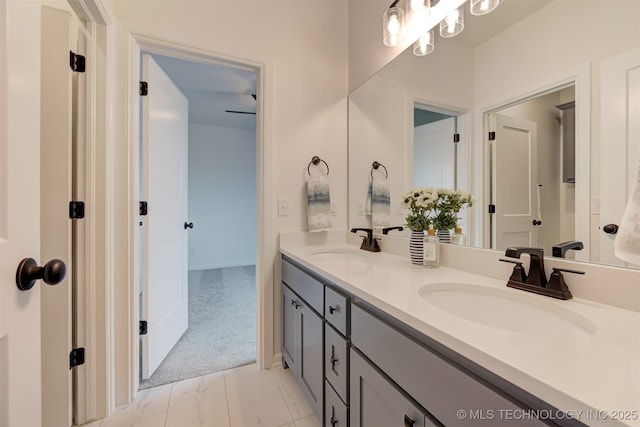 full bathroom with double vanity, a sink, and marble finish floor