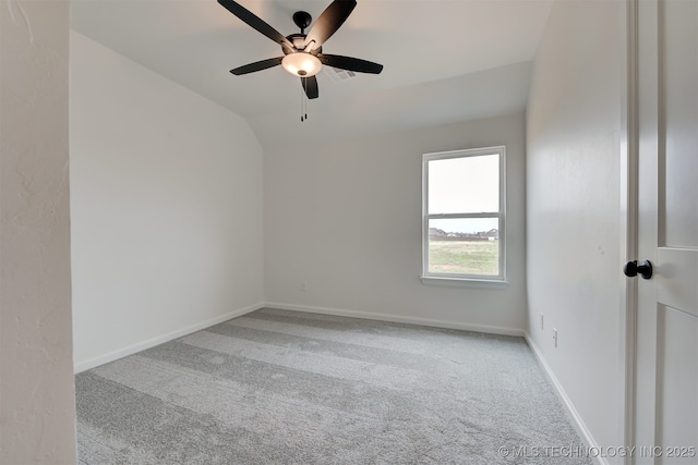empty room with carpet floors, baseboards, ceiling fan, and lofted ceiling
