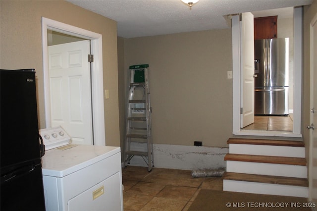 clothes washing area featuring laundry area and washer / clothes dryer