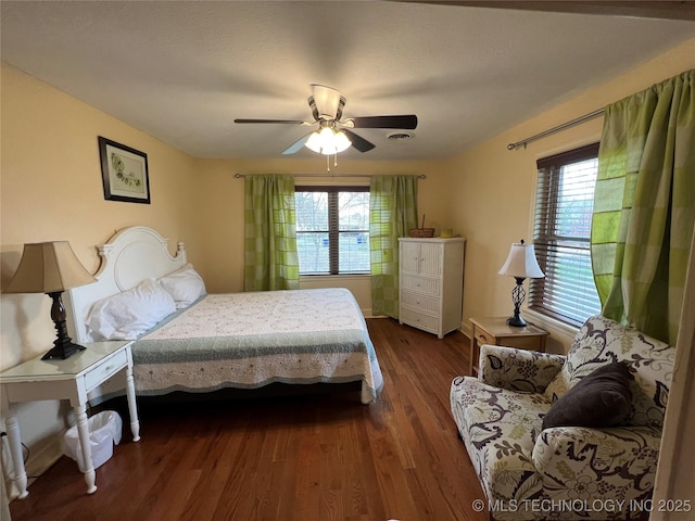 1029 N Kenwood Ave, Broken Arrow, OK 74012 - bedroom featuring dark wood-style flooring, ceiling fan, and multiple windows