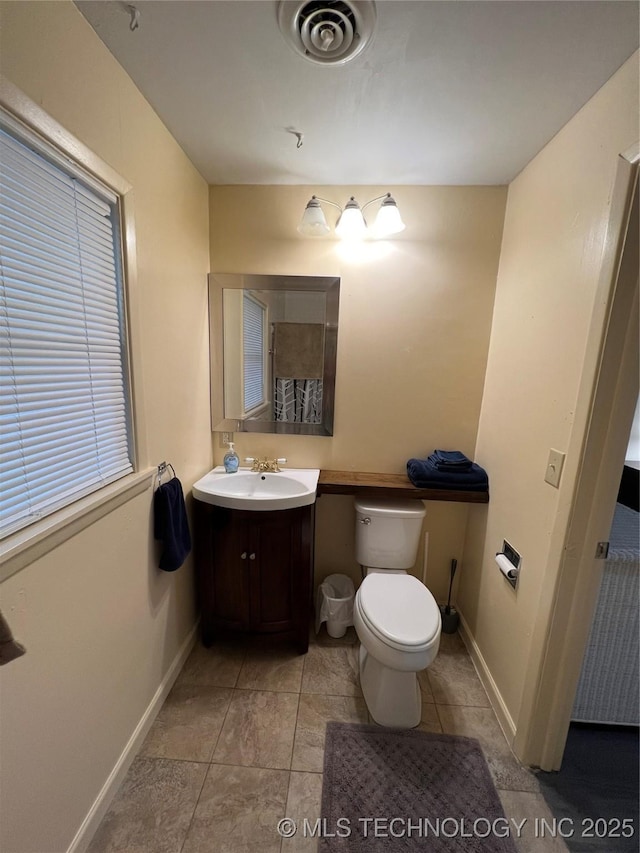 1029 N Kenwood Ave, Broken Arrow, OK 74012 - bathroom with visible vents, tile patterned flooring, vanity, toilet, and baseboards
