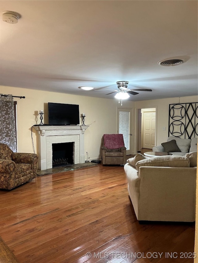 1029 N Kenwood Ave, Broken Arrow, OK 74012 - living room with a ceiling fan, visible vents, hardwood / wood-style flooring, and a fireplace