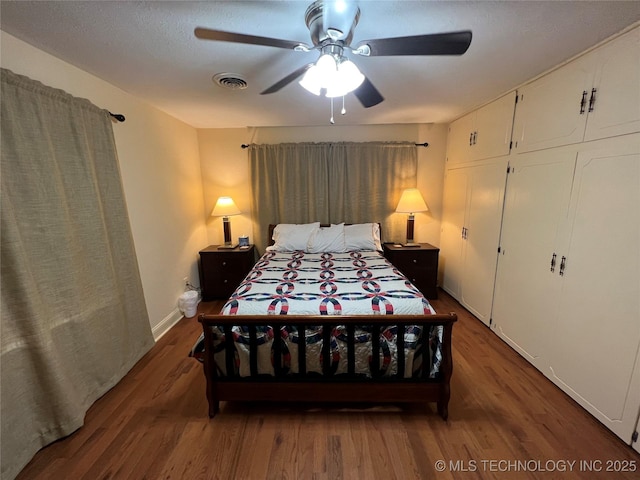 1029 N Kenwood Ave, Broken Arrow, OK 74012 - bedroom with baseboards, ceiling fan, wood finished floors, and visible vents