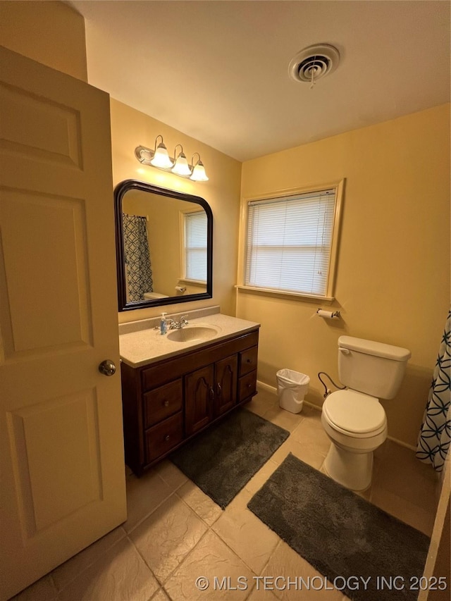 1029 N Kenwood Ave, Broken Arrow, OK 74012 - bathroom featuring vanity, toilet, tile patterned floors, baseboards, and visible vents