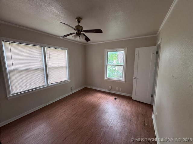 empty room with ceiling fan, a textured ceiling, ornamental molding, and wood finished floors