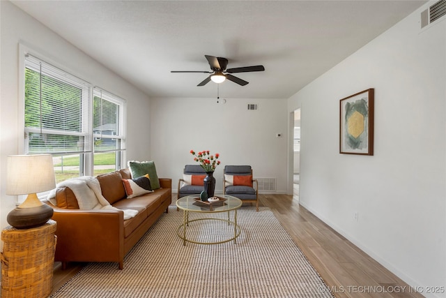 living area featuring ceiling fan, wood finished floors, and visible vents