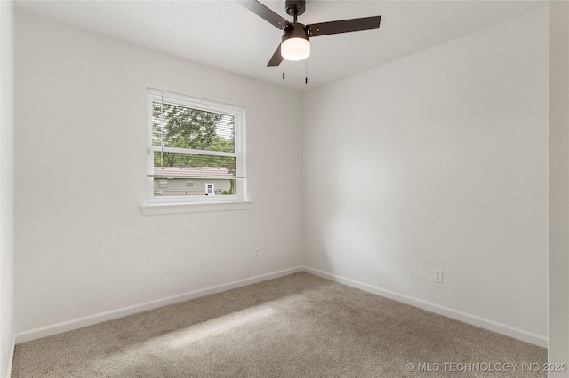 carpeted empty room featuring baseboards and ceiling fan