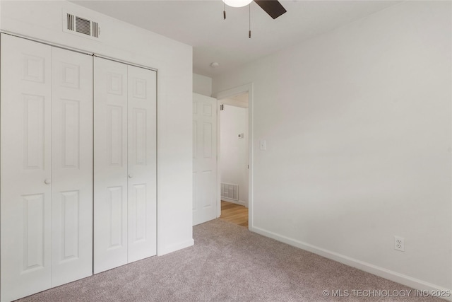 unfurnished bedroom with carpet floors, baseboards, a closet, and visible vents