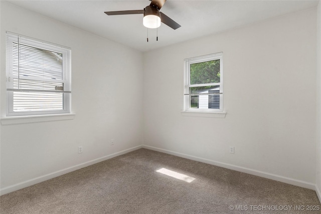 carpeted spare room with baseboards and ceiling fan
