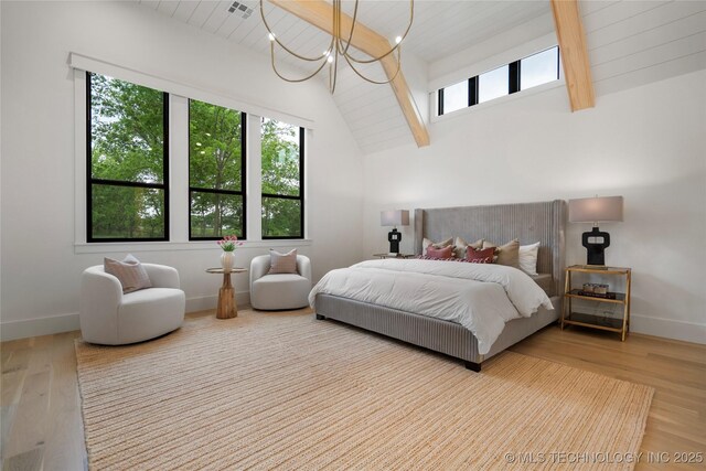 bedroom featuring an inviting chandelier, baseboards, beam ceiling, and wood finished floors