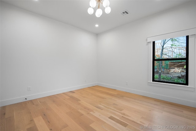 unfurnished room with a chandelier, light wood-style flooring, recessed lighting, baseboards, and visible vents