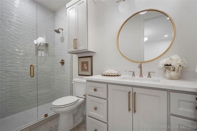 full bathroom featuring vanity, tile patterned floors, a stall shower, and toilet
