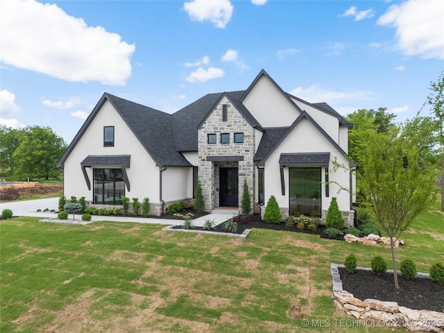 modern farmhouse with a shingled roof, a front lawn, stucco siding, and stone siding
