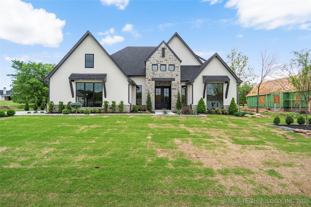 view of front facade with a front lawn, stucco siding, french doors, and stone siding