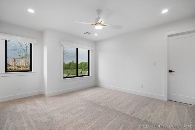 carpeted empty room with visible vents, recessed lighting, and a wealth of natural light