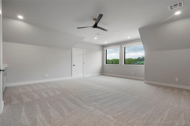 bonus room with visible vents, a ceiling fan, baseboards, and light colored carpet