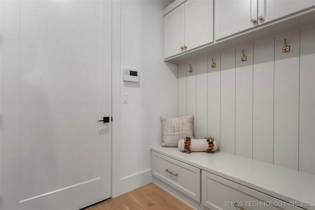 mudroom with baseboards and light wood-style flooring