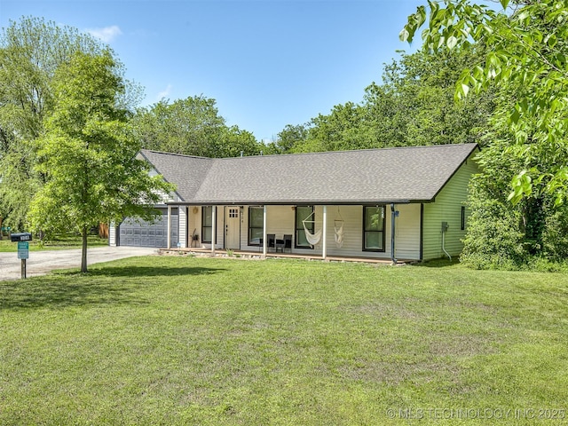 single story home with an attached garage, a porch, driveway, and a front yard