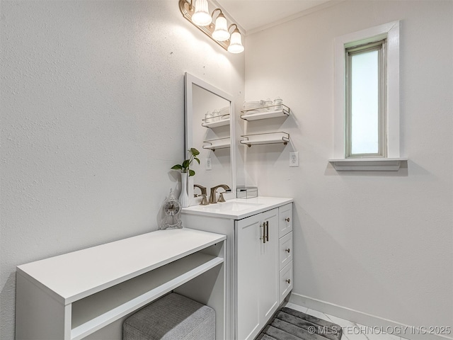 bathroom with vanity and baseboards