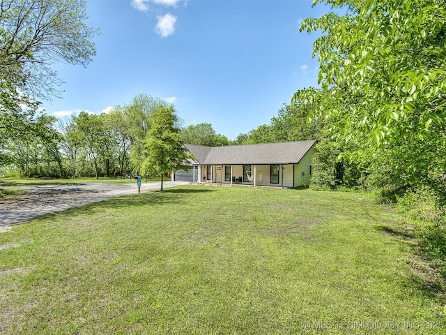 ranch-style house with a porch, driveway, and a front yard