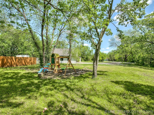 view of yard with a playground and fence